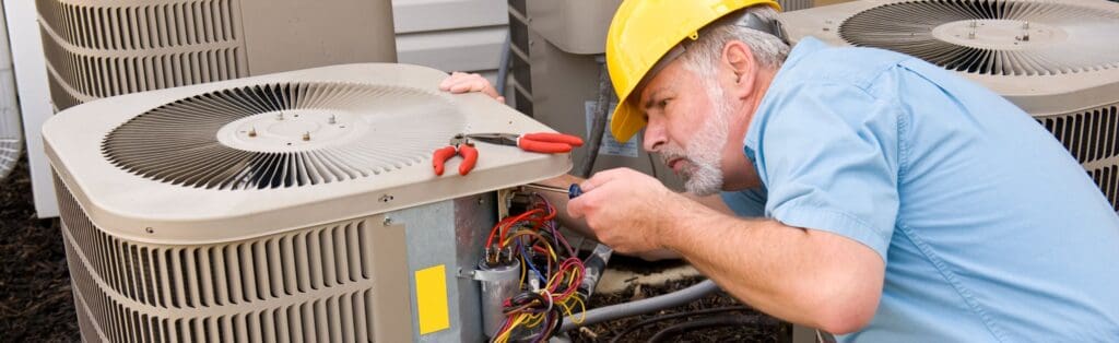 ACE Heating and Appliance technician repairing an outdoor AC unit